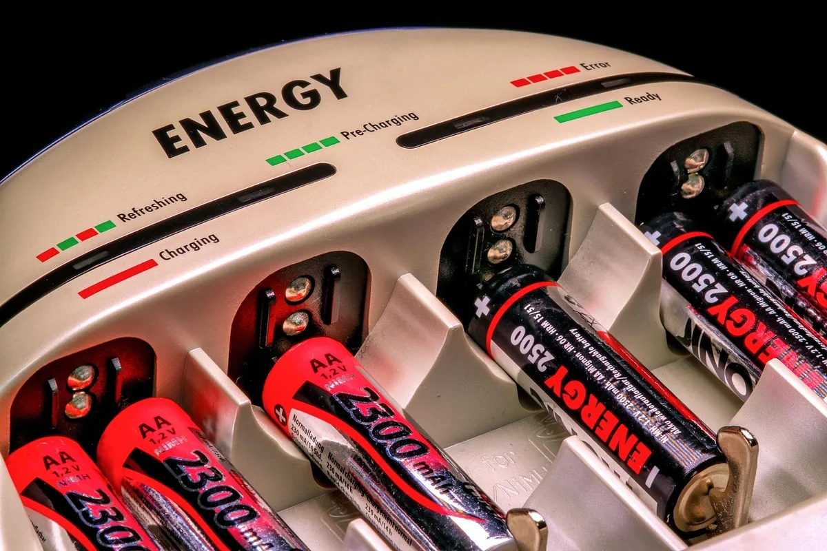 Personne branchant un chargeur sur une batterie de vélo électrique